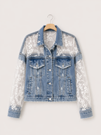Denim jacket with lace and sequin sleeves on a hanger against a white background